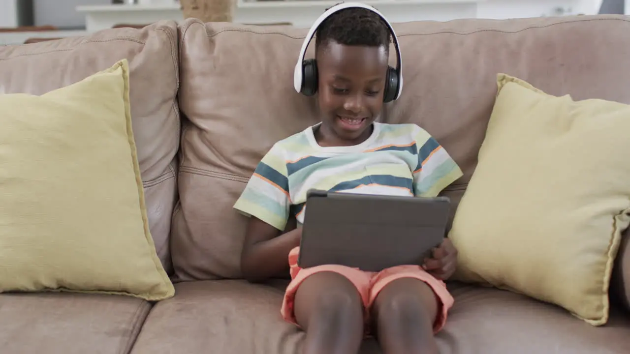 African American boy enjoys digital content at home using a tablet