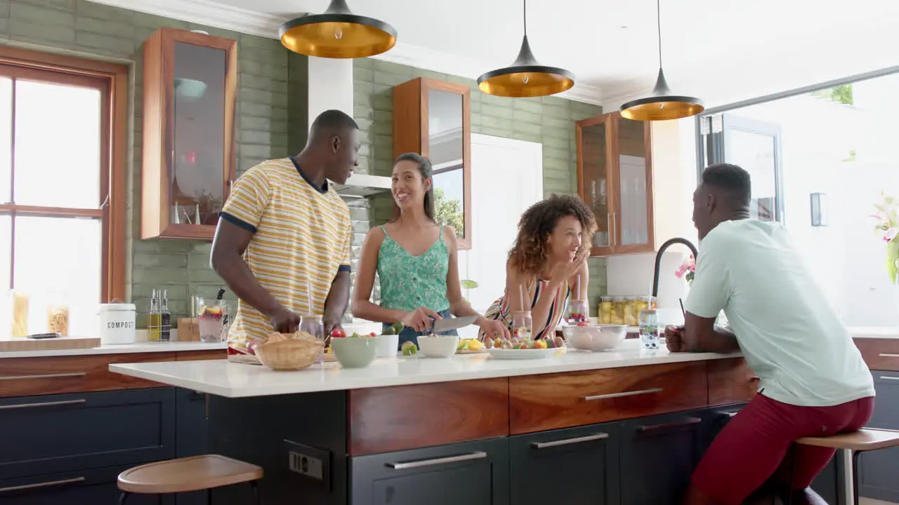 Diverse group enjoys a conversation in a modern home kitchen