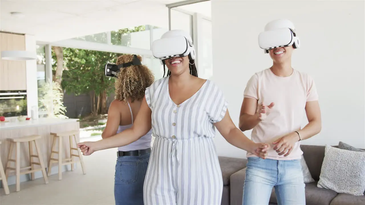 Diverse friends enjoy virtual reality games at home