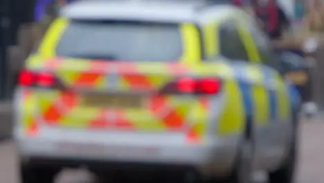 Defocused Shot of Police Car In City Centre