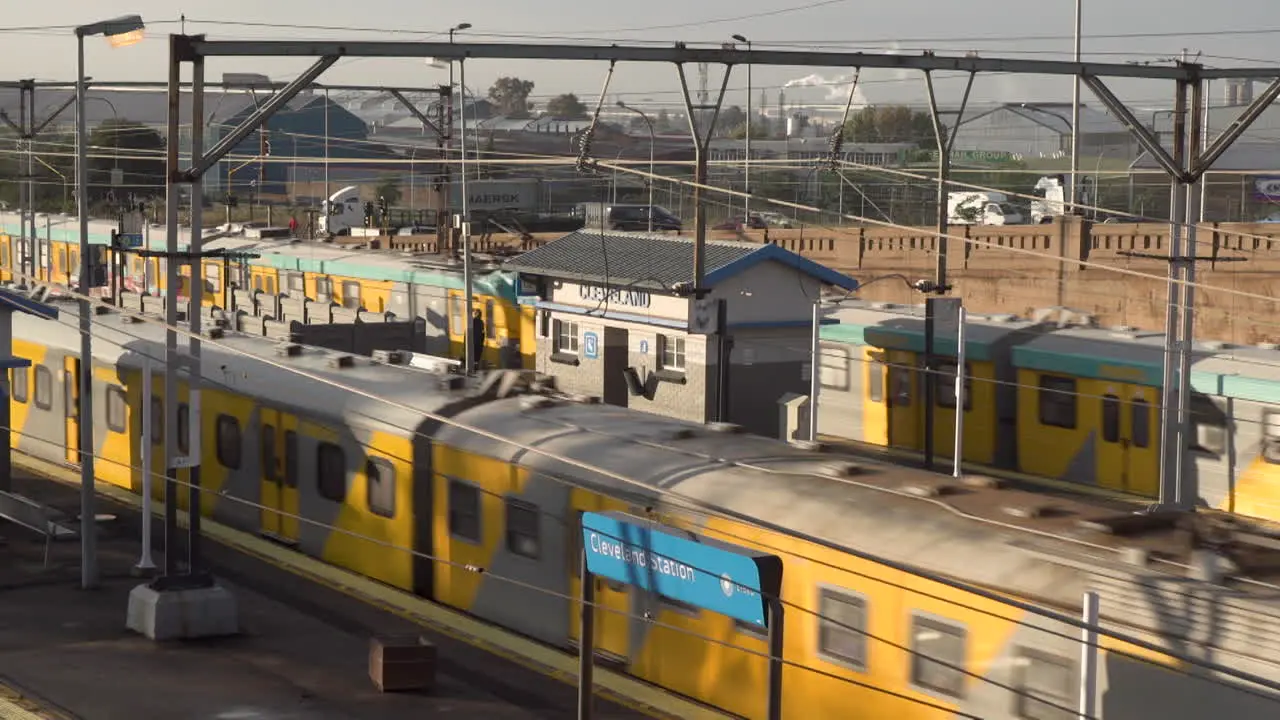 Metrorail commuter trains passing through Cleveland Station in Johannesburg morning rush hour