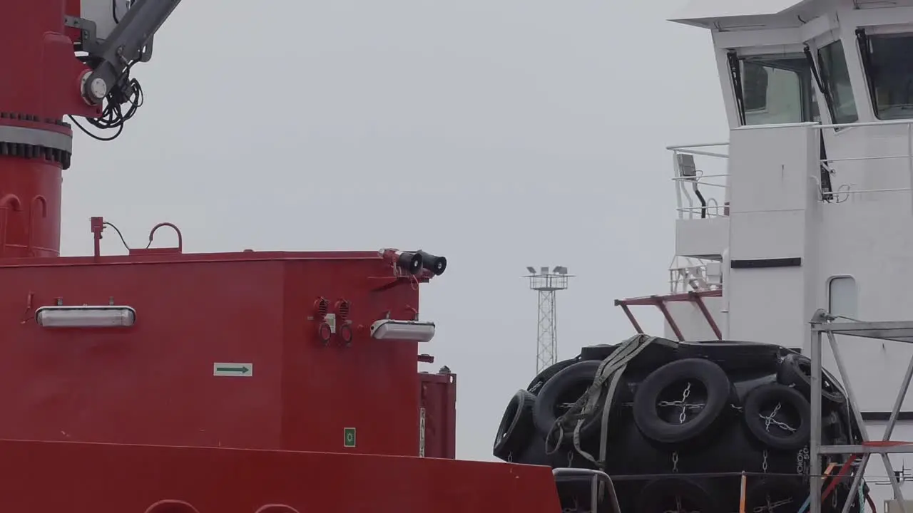 View Through docked Ship Of Another Large Ship Going Past