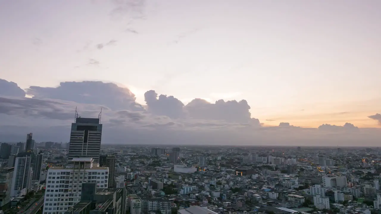 Time lapse of cloud movement over Bangkok cityscape during golden hour