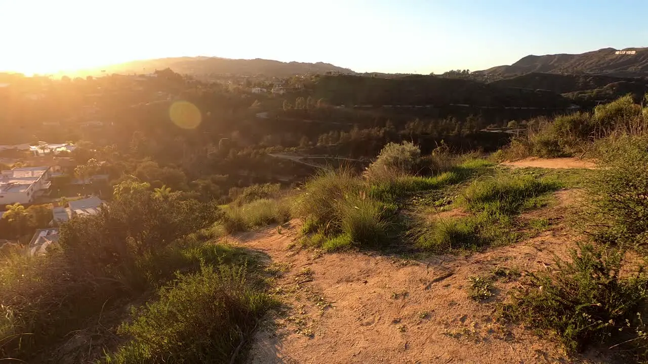 Wide pan shot of Los Angeles at sunset seen from the Hollywood Hills