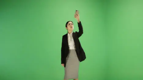 Woman finding phone signal on green screen