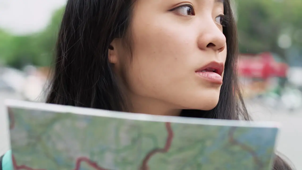 Handheld view of Vietnamese tourist reading a map