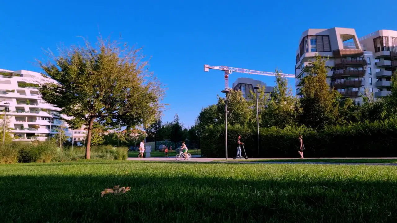 park green area residential building in the city with modern apartment and pedestrian cycles during a sunny day of summer