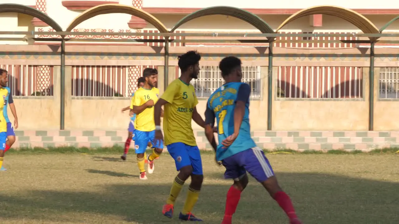 Close up shot of teenager playing football in the ground of Karachi