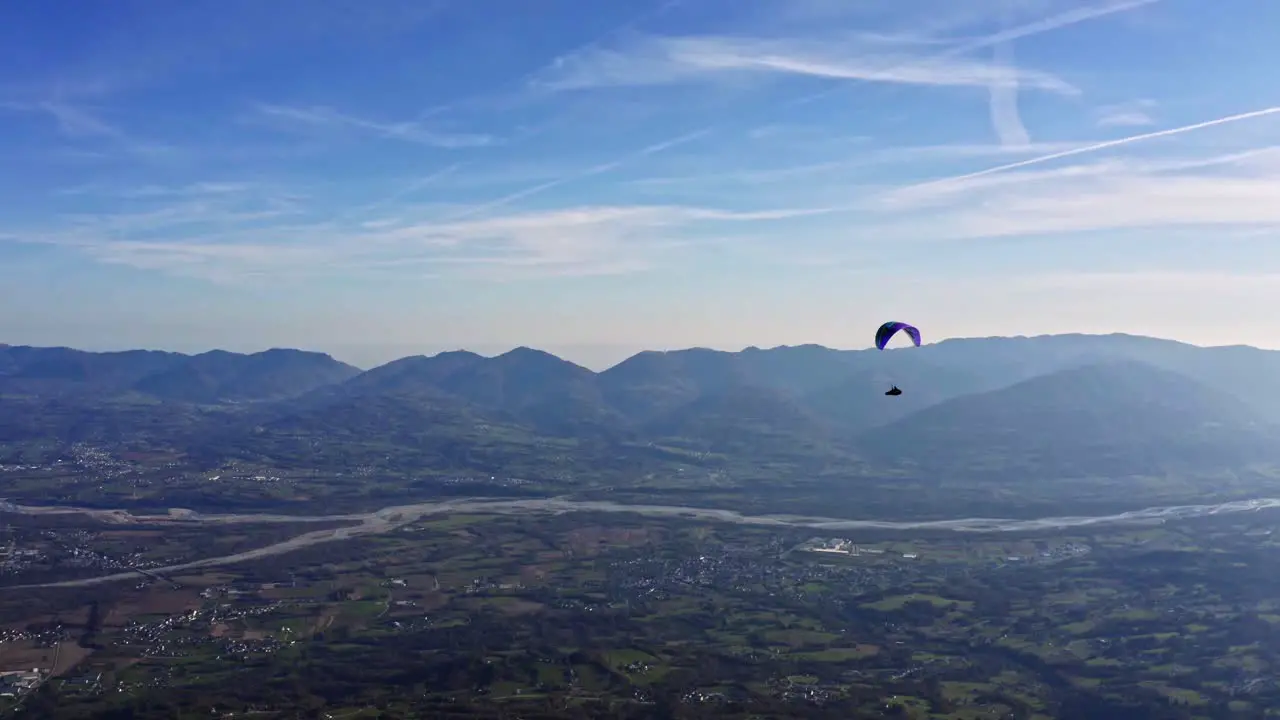 colorful paraglider in air with Piave river in background adventure sport