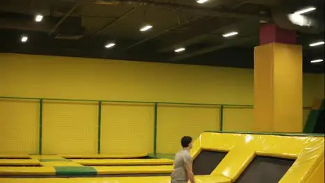 Unbelievable back double somersaults one after one performed by professional young male athlete on the trampoline