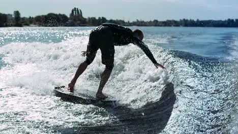 Wake surfer falling in water in slow motion Man rotating on wake surf