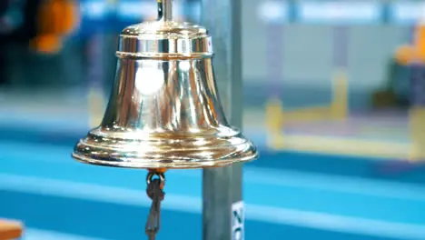 Referee ringing bell at finish of competition Sports handbell closeup