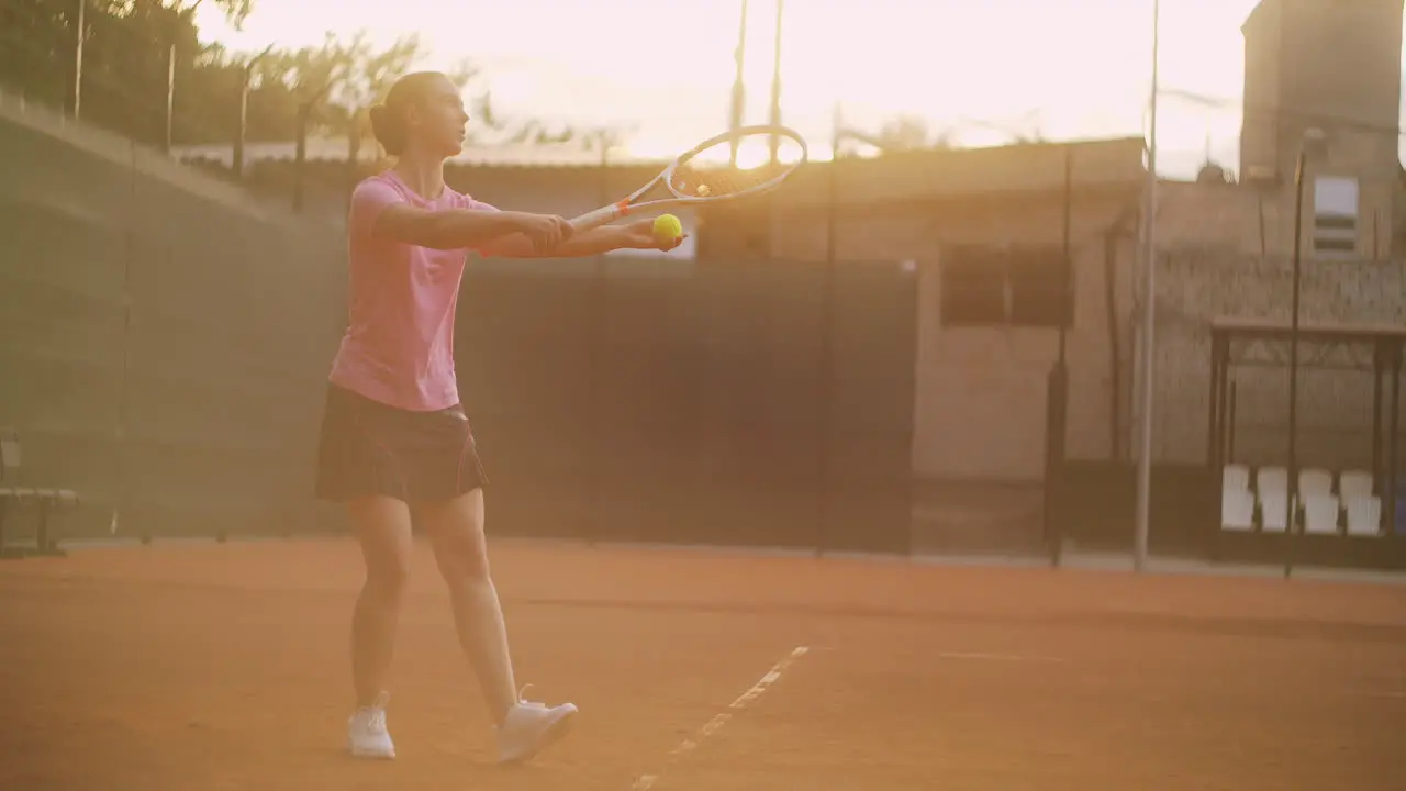 Slow motion A female tennis player strikes the ball while serving tennis supply