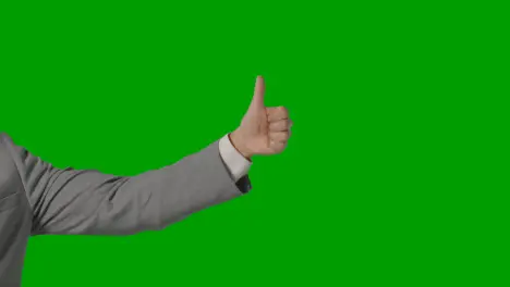 Close Up Of Arm Of Businessman In Suit Giving Thumbs Up Gesture Against Green Screen 1