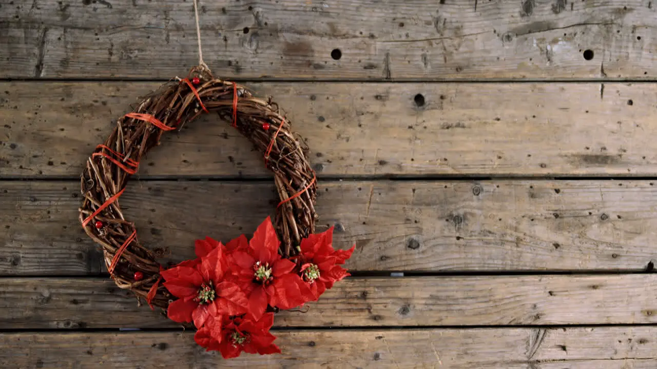 Grapevine wreath with flowers on wooden table 4k