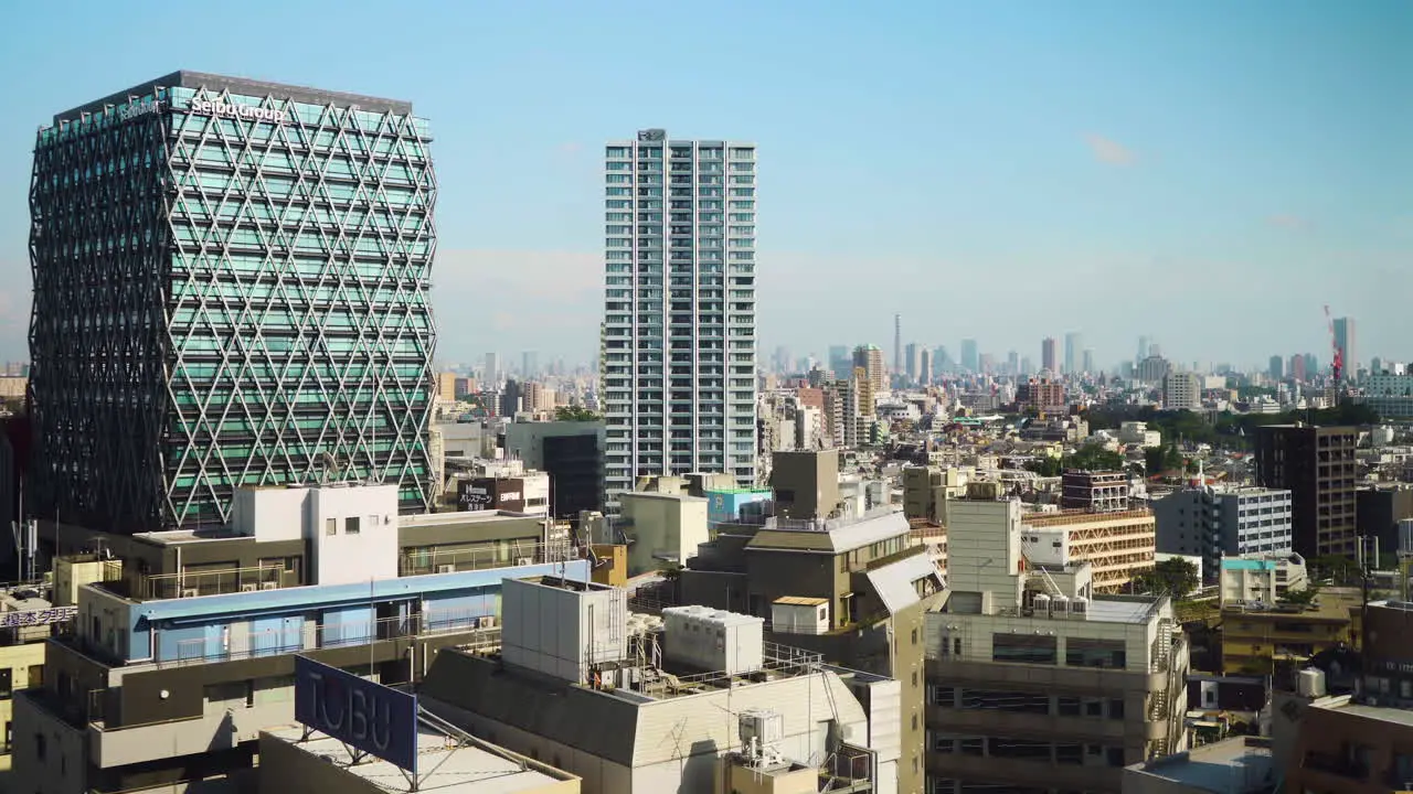 Panoramic view of Tokyo skyline with densely packed buildings on a sunny afternoon