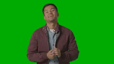 Portrait Of Casually Dressed Smiling Young Man Against Green Screen 2