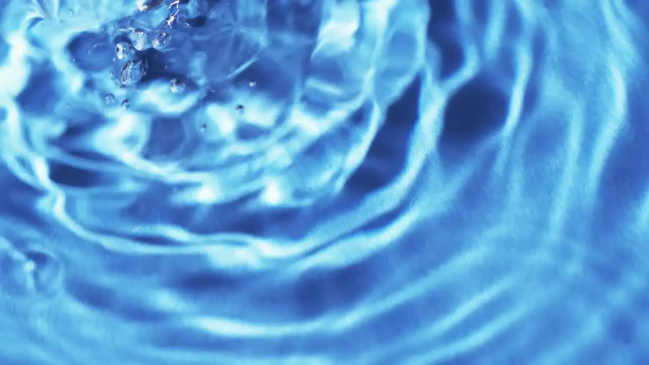 Video of close up of drops of water with copy space on blue background