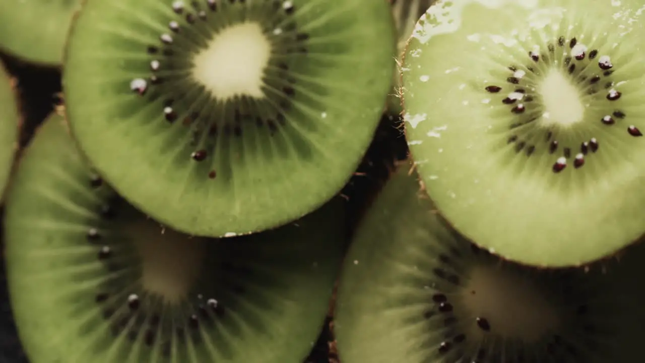 Micro video of close up of slices of kiwi fruit with copy space