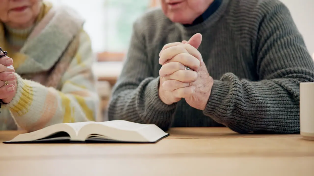 Hands senior couple and bible for praying