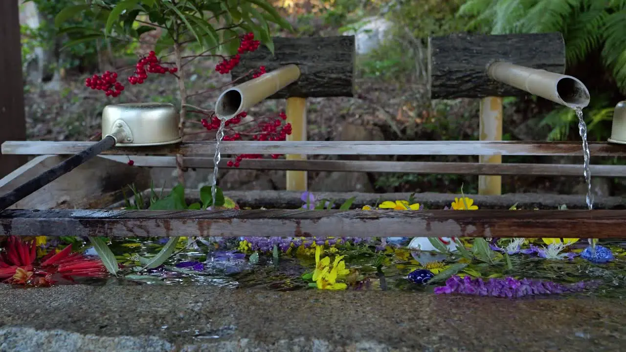 Slow cinematic slider across water ladles at typical Japanese shrine