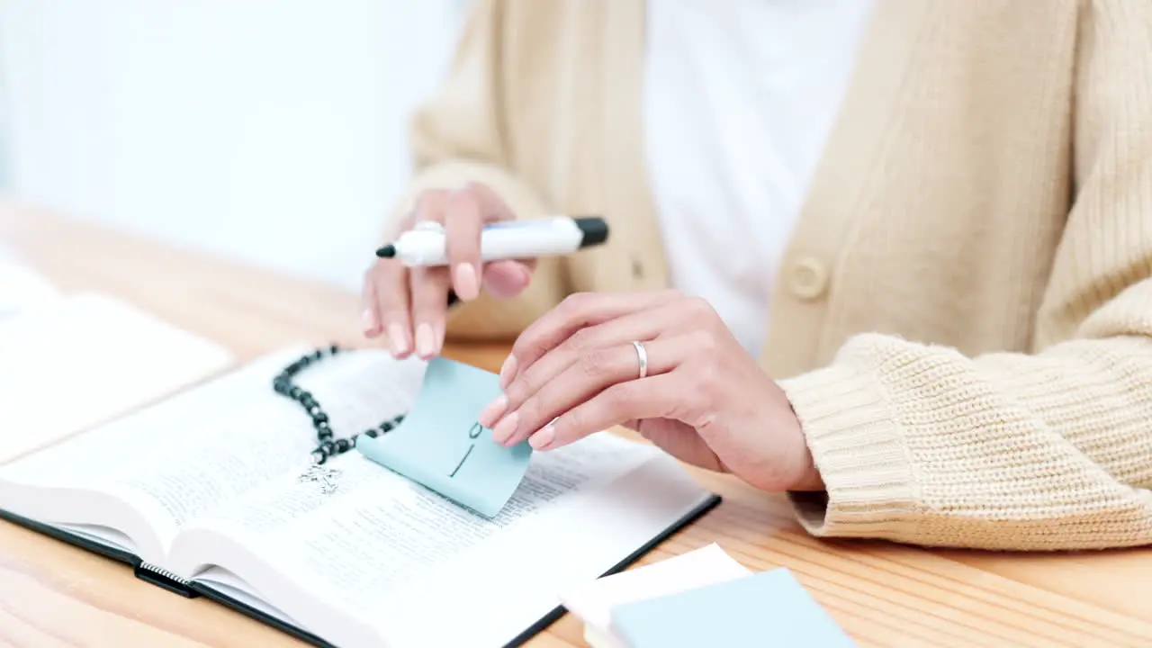 Hands writing and notes for bible study