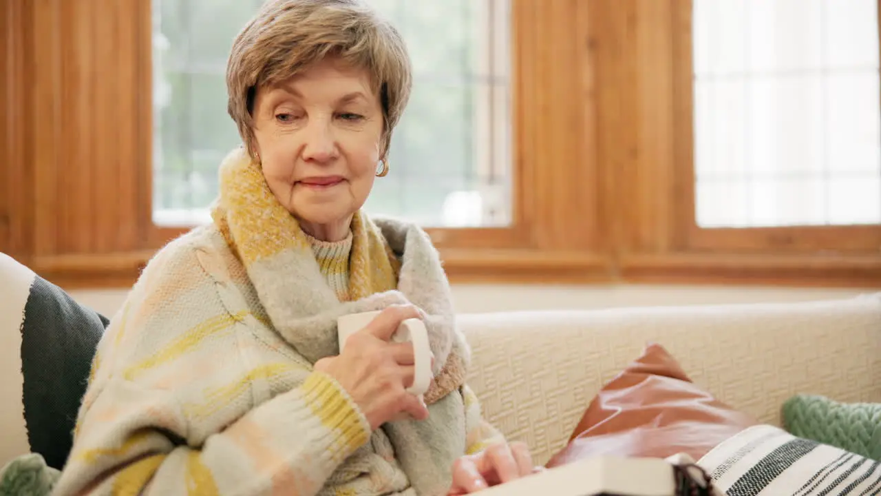 Coffee bible and senior woman on sofa in home