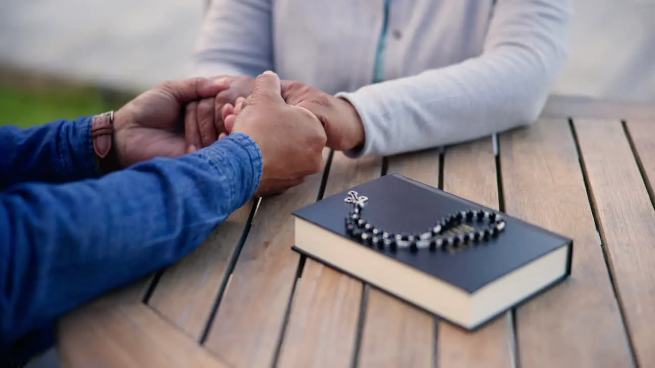 Couple holding hands and praying together