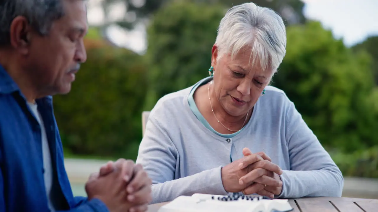 Old people in park praying with Bible