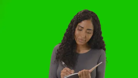 Portrait Of Female College Or University Student Against Green Screen Smiling At Camera 3