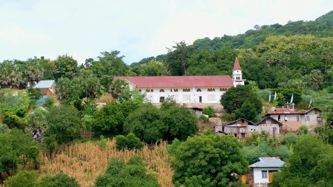 Beautiful church perched on the hill of a tropical island surrounded by green trees in Alor Island East Nusa Tenggara Indonesia