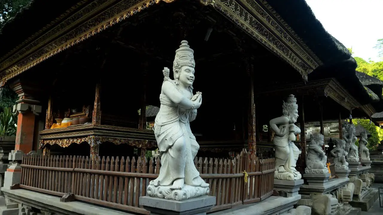 Establishment slow motion shot of a religious building with various sacred sculptures in pura tirta empul temple on bali indonesia in ubud