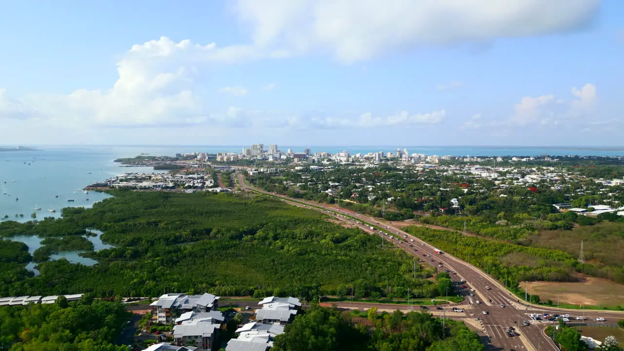 Areal panorama following a freeway into a coastline city