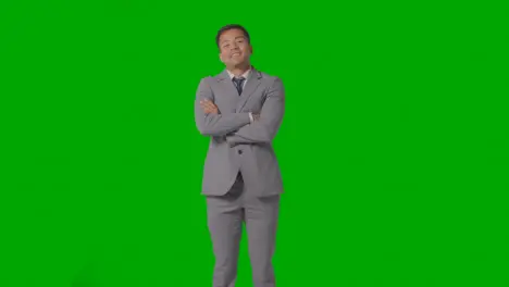 Three Quarter Length Portrait Of Businessman In Suit Against Green Screen Smiling At Camera 1