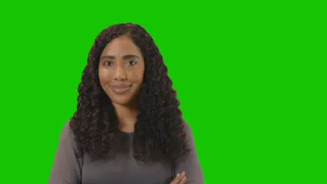 Portrait Of Woman Against Green Screen Smiling At Camera 2