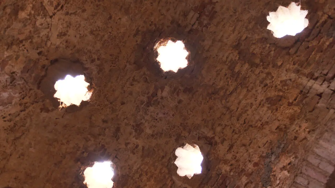 4k rotating down up view of Arabic baths ceiling in Ronda Malaga Spain historic Arabic culture ruins in Spain