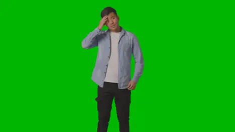 Studio Shot Of Casually Dressed Stressed Young Man With Headache Against Green Screen 1