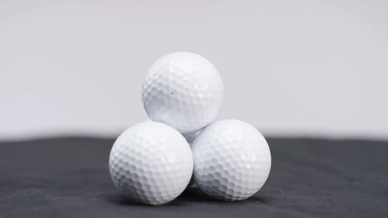 stack of white golf galls in studio