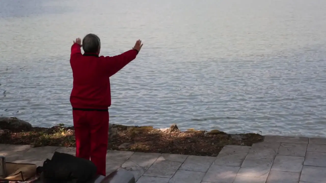 man doing yoga by the water in china in guilin