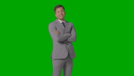 Three Quarter Length Portrait Of Businessman In Suit Against Green Screen Smiling At Camera 2