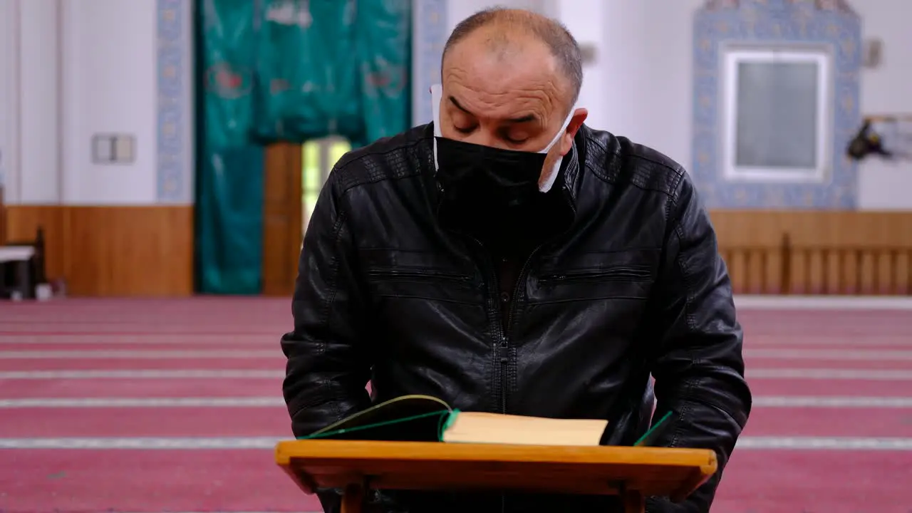 Old Masked Man Reading Quran During Ramadan