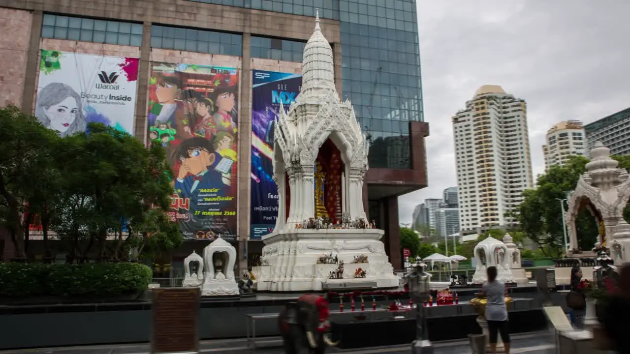 Busy Buddhist Hindu Temple Shrine in front of Modern Shopping Mall in Bangkok Hyperlapse