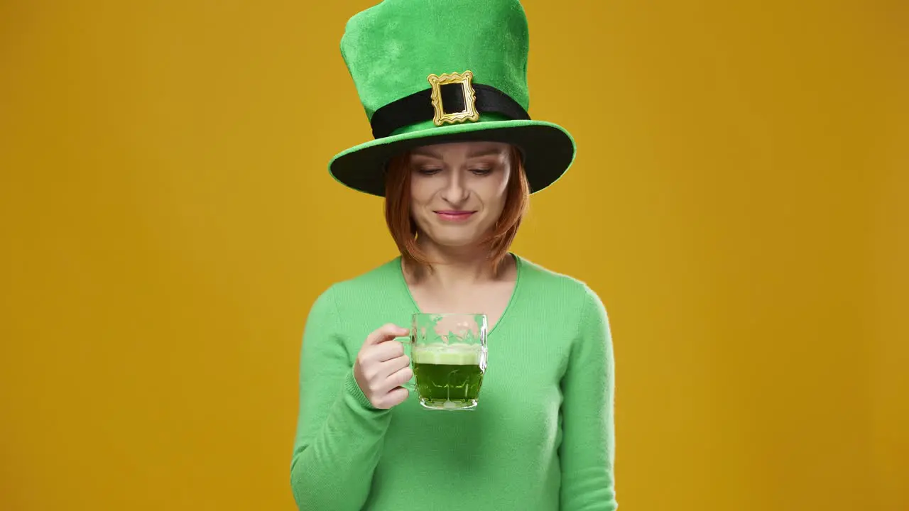 Woman drinking beer in studio shot