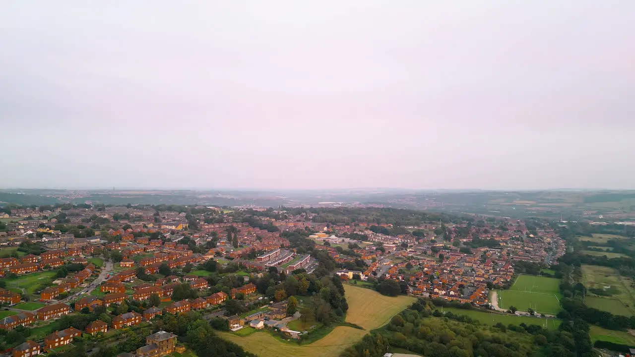 Drone footage showcases the fame of Dewsbury Moore Council estate a renowned UK urban housing complex red-brick terraced homes and the industrial Yorkshire landscape on a summer evening