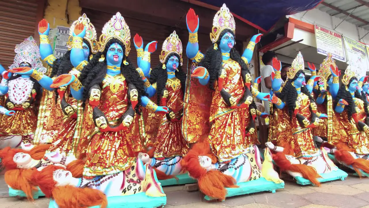 Completed Indian goddess Maa Kali idols being sold in Indian market slow smooth camera movement