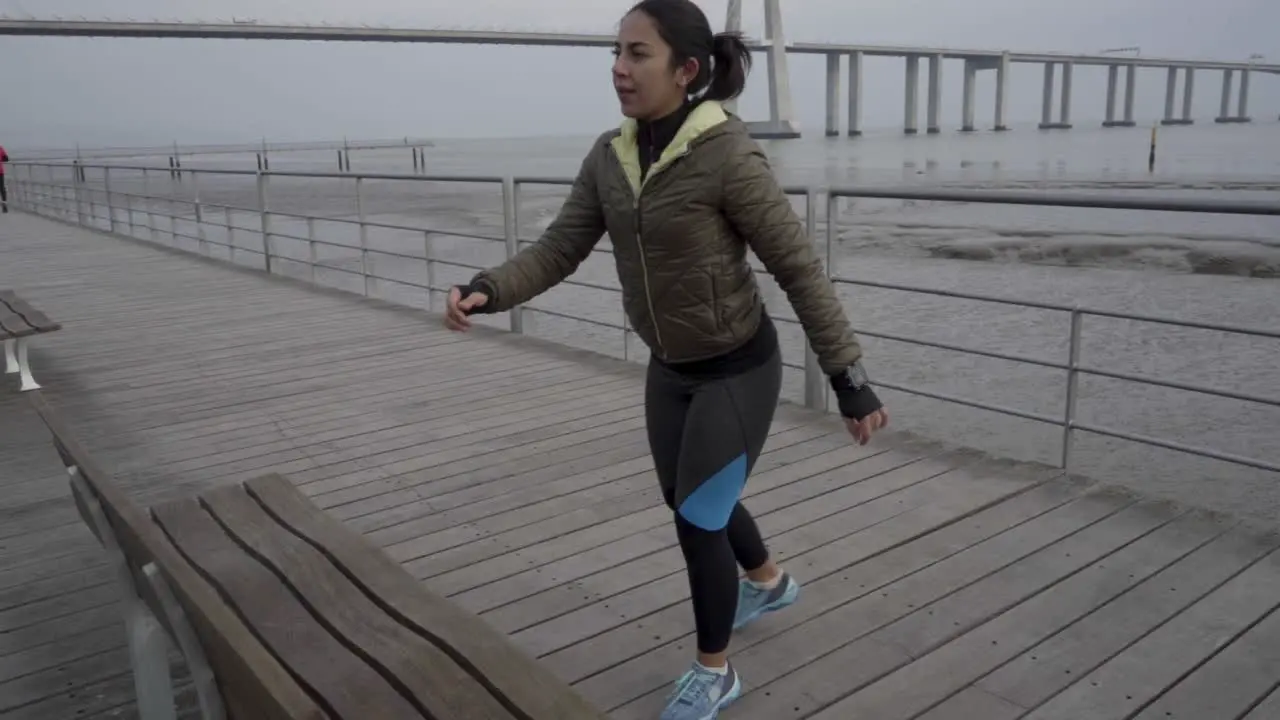 Confident young hindu woman training on seaside