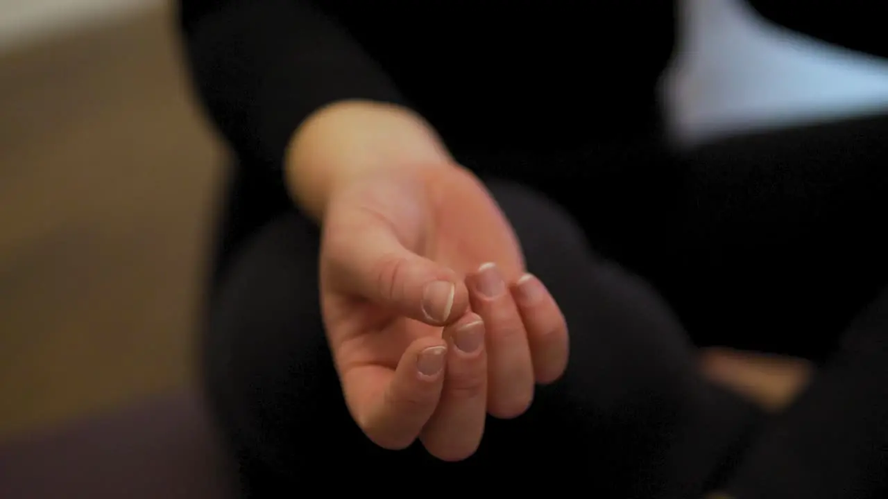 Closeup shot of female yoga instructor's hand in her fitness studio