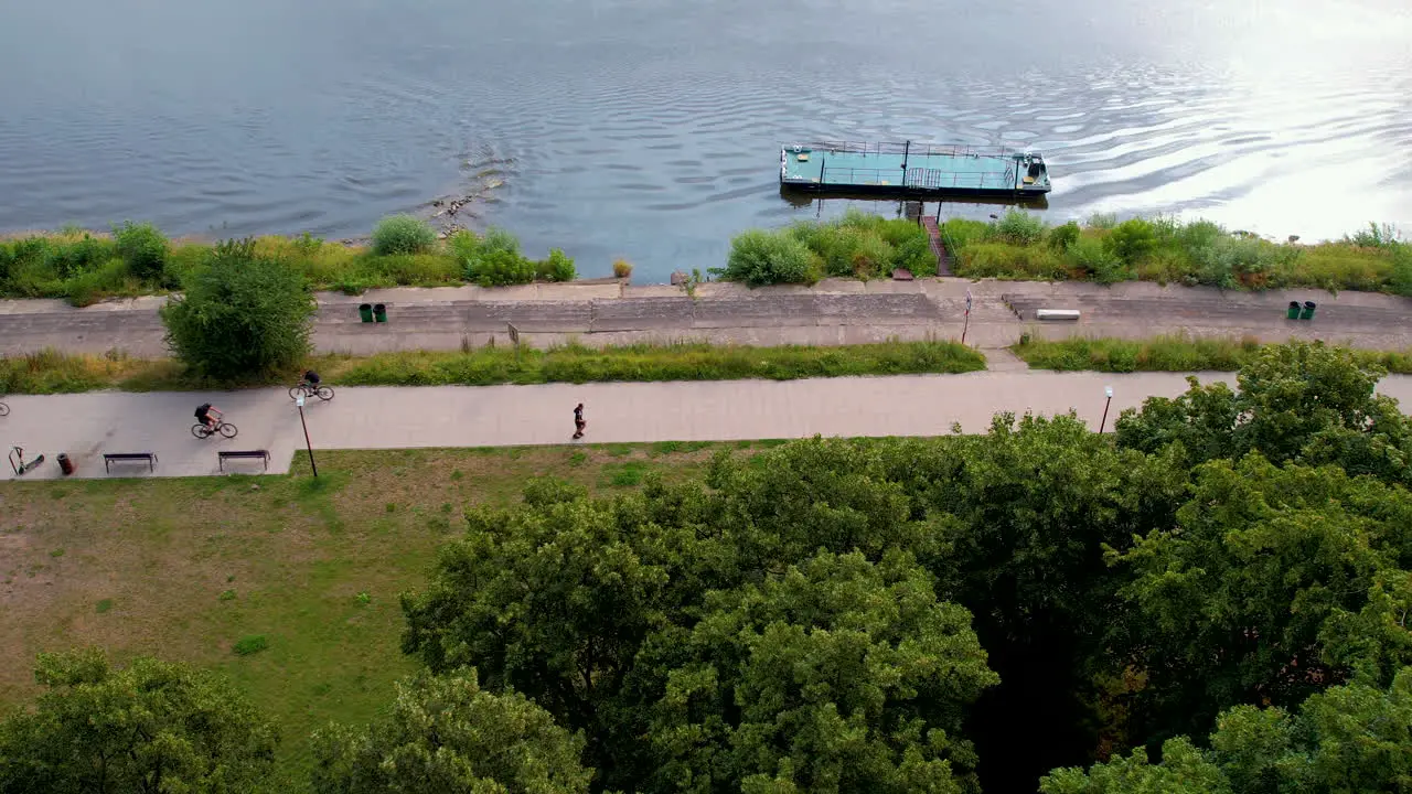 People immerse in healthy activities such as cycling jogging near river banks