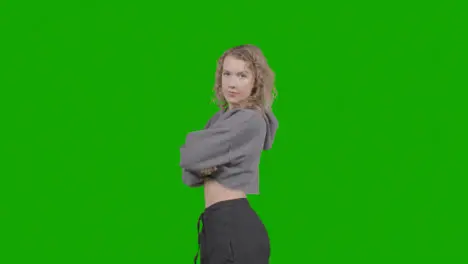 Studio Portrait Of Young Woman With Attitude Against Green Screen