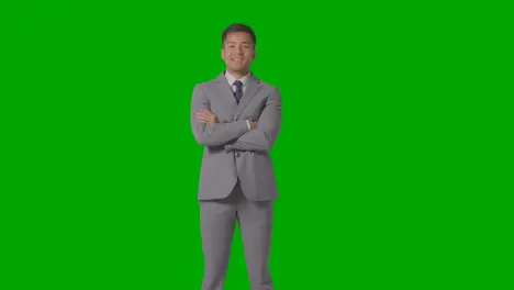 Three Quarter Length Portrait Of Businessman In Suit Against Green Screen Smiling At Camera 3